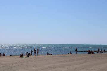 people on the beach of ostia near rome italy 