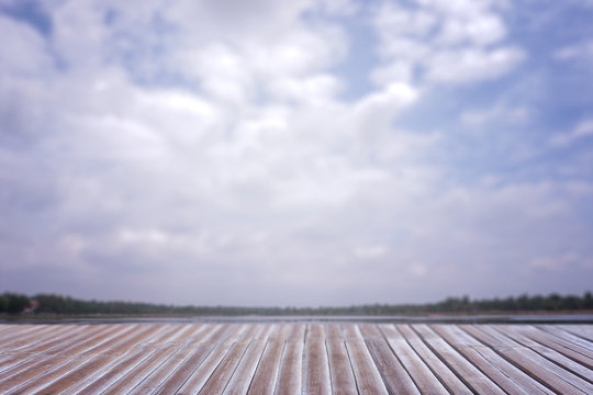 Wood floor and blurred sky for background.
