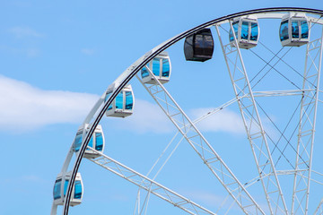Ferris wheel on a blue sky background