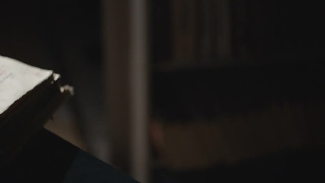 Slode shot of leafing through old book