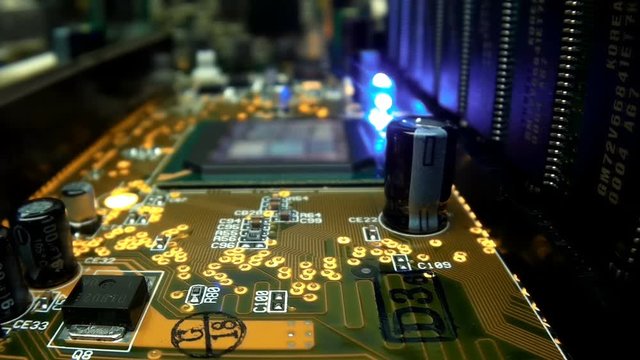 The camera slowly moves over the printed circuit board with main processor, on which seen the entire internal structure of the microchip. A blinking LED indicates data miscalculation. Macro. Closeup. 