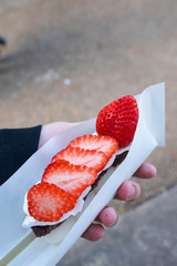 rice cake with cream and sweet red bean topped with seasoned strawberry also known as hanami dango stick; is a staple street food in Kyoto