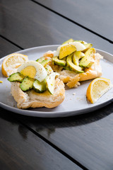 a Filipino bread with toasted garlic butter topped with avocado and egg also known as avocado toast