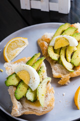 a Filipino bread with toasted garlic butter topped with avocado and egg also known as avocado toast