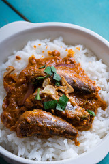 tomato sardines with crab fat on topped of rice or also known as aligue rice in the Philippines