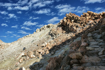 The way to the top of the Teide volcano. Stone path in the mountains to the top.