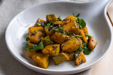 sweet and salty baked pumpkin with fresh rosemary and arugula 
