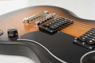 Fototapeta premium Electric Guitar detail of volume and tone controls over white background ideal for music lessons signs