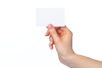 Fototapeta premium Female hand with blank white business card isolated on white
