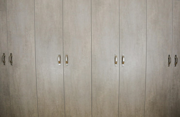 Gray cupboard. Cabinet doors. Furniture.