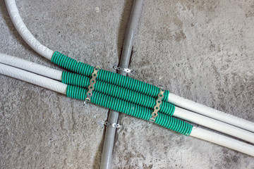 Installing plumbing in the kitchen. Plastic pipes are installed in a cement wall. Concept- renovation, construction of a new house.