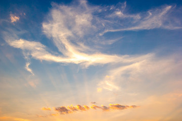 Colorful sunset sky above clouds with dramatic light in twilight time. Beautiful sunset background