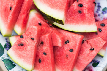 Cut into pieces watermelon and neatly laid out on a plate