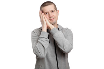 tired man put his hands under his head, wants to sleep. Dressed in sportswear. Isolated