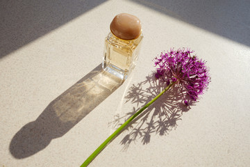 
glass perfume bottle with a gray flower and beautiful shades