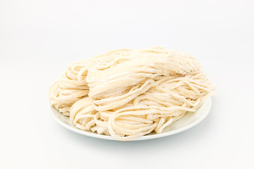 Thick noodles made from wheat flour on white background