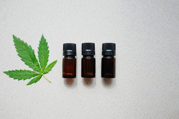 
medical bottles made of dark glass with leaves of hemp. The concept of the use of hemp for medical purposes
