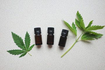 
medical bottles made of dark glass with leaves of hemp. The concept of the use of hemp for medical purposes
