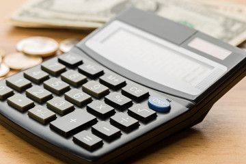 Coin money and banknote bills with a calculator. ballance reduction