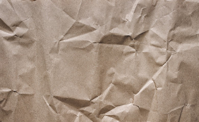 Background from old crumpled light brown wrapping vintage paper. The texture of cardboard made from...