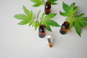 
medical bottles made of dark glass with leaves of hemp. The concept of the use of hemp for medical purposes