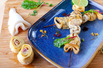 grilled squid rings and artichoke on wooden skewers