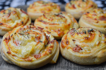 Obraz na płótnie Canvas Homemade pizza rolls with mozzarella, ham and spelt flour, close up
