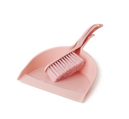 pink plastic scoop and cleaning brush