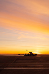 Fototapeta premium Silhouette of a plane in the airport on the dawn