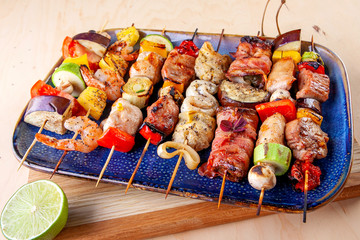 seafood meat bacon grilled vegetables on wooden skewers