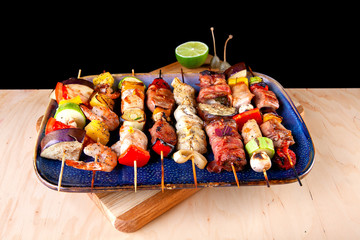 seafood meat bacon grilled vegetables on wooden skewers