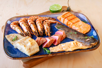assorted different types of fish and shrimp on a plate