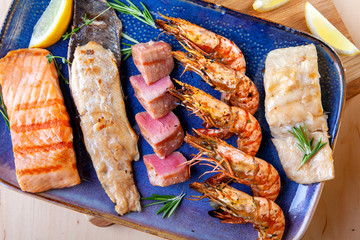 assorted different types of fish and shrimp on a plate