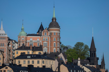 Sunny morning view over old house part of the district of Södermalm, above the waterfront at the bay Riddarfjärden and the sluice part in Stockholm. 