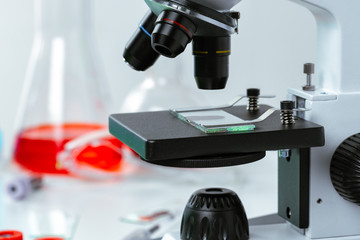 Fototapeta na wymiar Close up photo of a microscope lenses examining glass sample