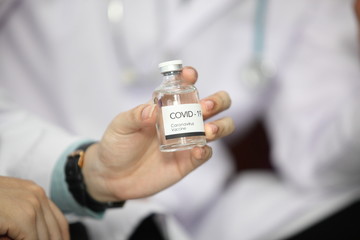 Doctor holding sample covid-19 vaccine vial with medication, closeup.