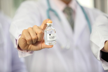 Doctor holding sample covid-19 vaccine vial with medication, closeup.