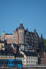 Sunny morning view over old house part of the district of Södermalm, above the waterfront at the bay Riddarfjärden and the sluice part in Stockholm. 