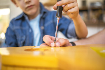 Cute Boy using a screwdriver	