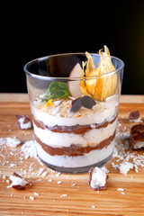 chocolate cream dessert with coconut in a transparent glass