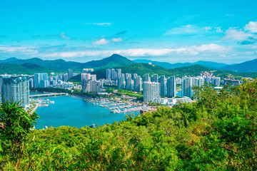 Fototapeta premium Sanya city, Hainan island. Aerial view of the city center from Luhuitou Park. Excellent tourism destination for summer vacation by the sea. Sanya is the southernmost city in China. Paradise island.