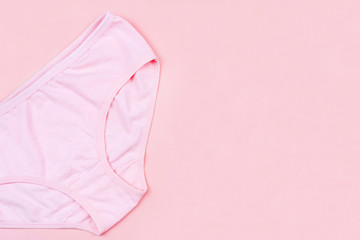 Top view Pink underpants isolated on pink background with copy space. Woman hygiene, Concept of critical days, menstruation,health care