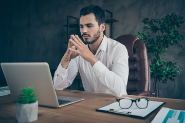 Portrait of his he nice attractive chic classy confident focused man skilled expert economist analyzing data stock exchange at modern loft industrial style interior workplace station
