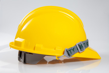 Yellow safety helmet on white background. Hard Hat or safety engineer helmet for construction site