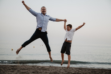 Father with son playing on the beach. Father's Day!