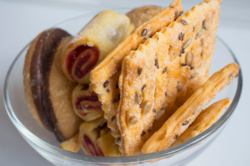 delicious variety of cookies with sesame, chocolate in a glass plate on the table