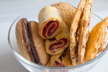 delicious variety of cookies with sesame, chocolate in a glass plate on the table