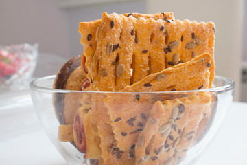 delicious variety of cookies with sesame, chocolate in a glass plate on the table