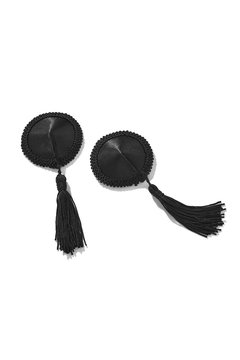 Detailed shot of two black fabric nipple covers decorated with lace ribbons and black silk tassels. The pair of pasties is isolated on the white background. 