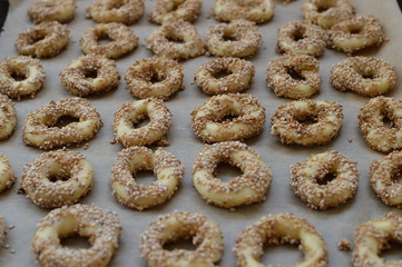 Salty traditional middle eastern sesame pastry with cumin, tuzlu kurabiye, taralli, on the backing sheet, selective focus